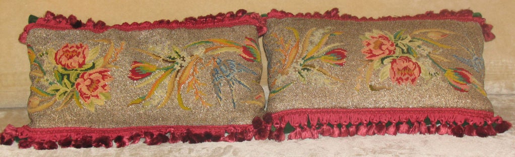 Fantastic pair of silver handbeaded and needlepoint art deco fragments as pillows in vibrant floral bouquets and charming bluebirds bordered by burgandy tassel trim and backed in rich hunter green velvet