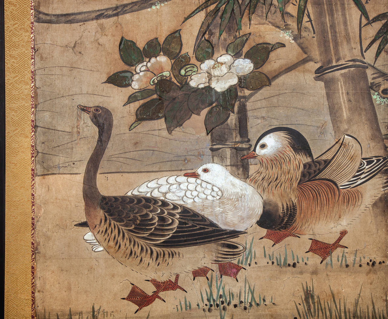 Japanese Two Panel Screen:  Mandarin Ducks and Geese Among Bamboo and Flowers, Edo period painting (c. 1850) of mandarin ducks and geese on a grassy shoreline with bamboo and white camellia flowers.  A beautiful early painting with heavy gold dust