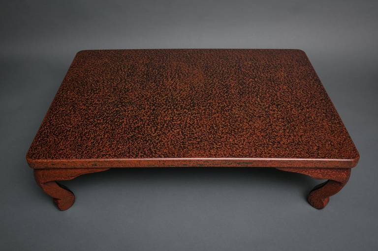 Wakasa red lacquer table with mother-of-pearl scattered throughout.