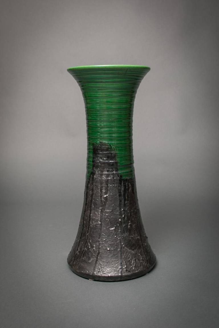 Large vase made for holding tall, heavy flowers or blossoming branches.