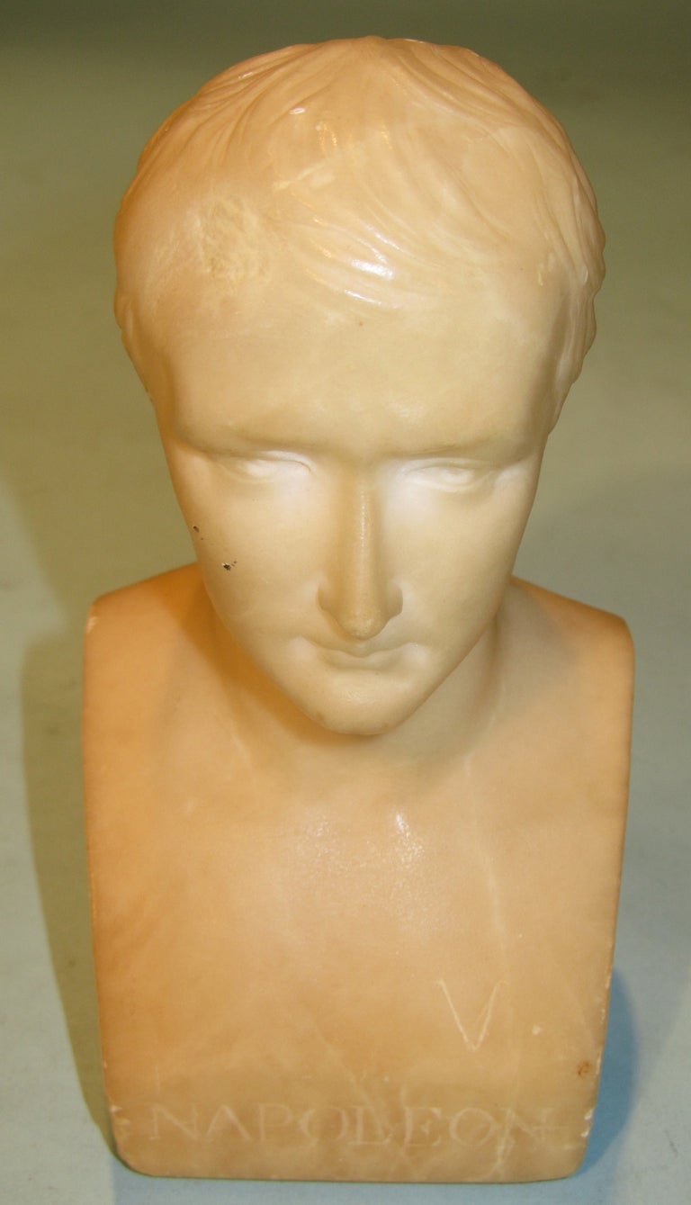 An attractive and interesting  collection of Grand Tour type items relating to Napoleon consisting of a marble bust, a bronze of a seated Emperor, a small bronze bust on a plinth and a ceramic standing figure of Napoleon.