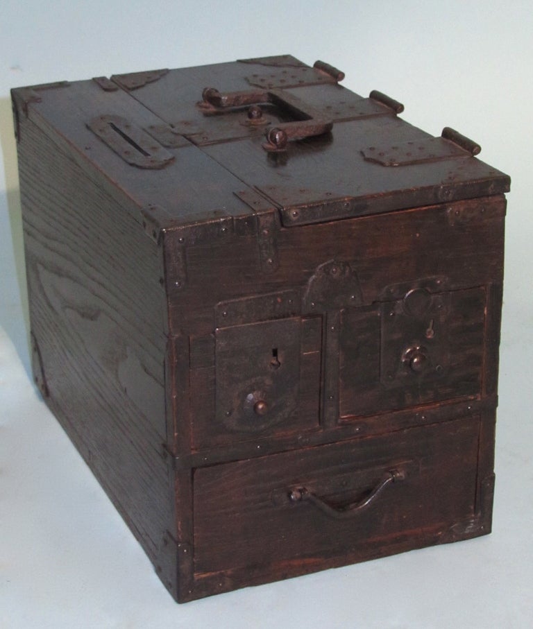 An attractive Japanese hardwood Edo period Zeni-Bako with multiple drawers, a foldover top and attractive iron mounts.