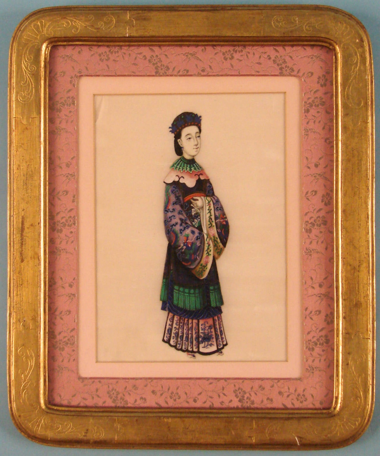 A pair of Chinese export paintings on pith paper depicting a noble man and woman in elegant court attire, circa 1900. Framed.