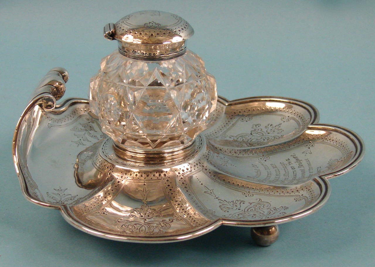 An English sterling silver inkstand the cut crystal bottle with a sterling cap mounted on a lobed stand bearing a dedication to a member of parliament on his wedding day. Made by Hands & Sons, hallmarked for London, 1872. Bears an interesting