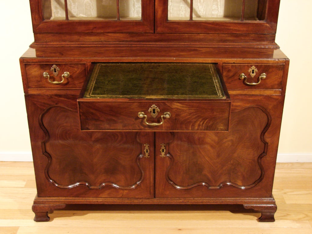 A fine quality George III mahogany secretary bookcase, the lattice form  broken pediment cornice above a pair of glazed doors with geometric mullions, the lower case fitted with 3 drawers, the central drawer with a leather lined surface and hidden