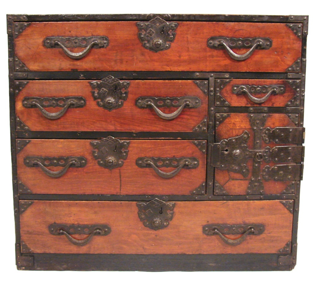 Charming Japanese Meiji period Keyaki wood tansu of small size consisting of 2 long and 5 small drawers with elaborate black lacquered hardware.