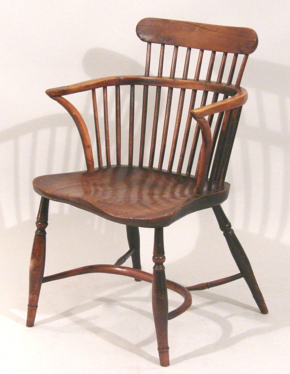 An English elm comb back Windsor armchair with crinoline stretcher.