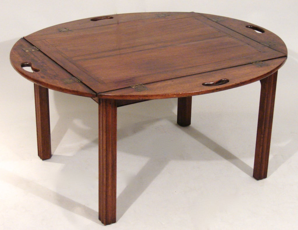 An attractive English mahogany butler's tray, the paneled top with folding sides, now on a custom stand of a later date.