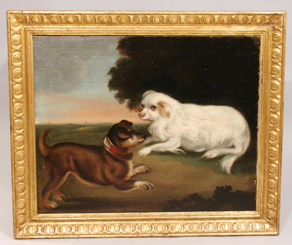 A charming English school naive oil on canvas depicting 2 frolicking  dogs in a landscape. Now in a giltwood frame.