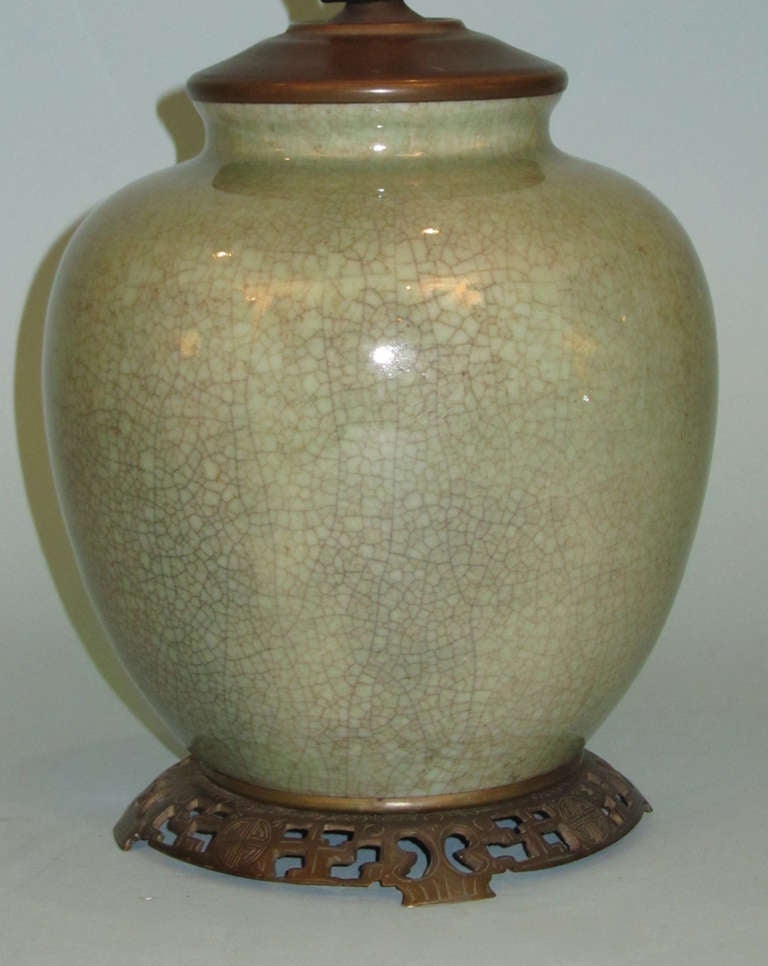 A Chinese celadon crackle glazed vase mounted with brass fittings, now drilled and electrified. Vase circa 1920.