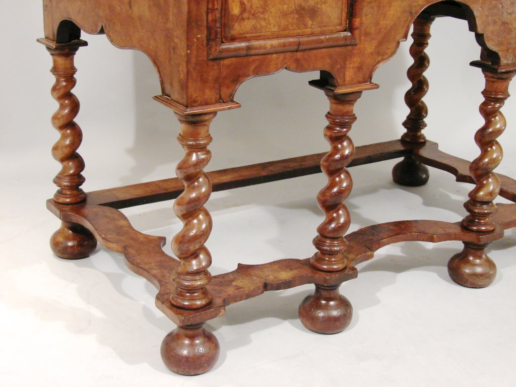 A William and Mary style burl walnut dressing table or lowboy, the crossbanded quarter veneered top with moulded edge above 3 chevron banded drawers, the whole supported by barley twist legs ending in bun feet.