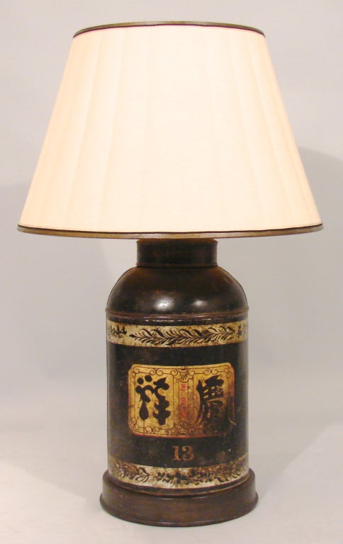 A Chinese black and gilt tea canister of large size decorated with Chinese characters, foliate trim and the number 