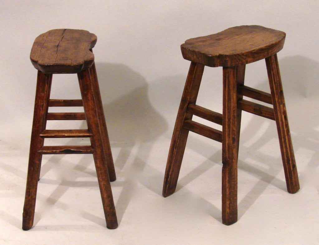 A pair of Japanese elm hand hewn wooden stools of simple design, circa 1880-1900.