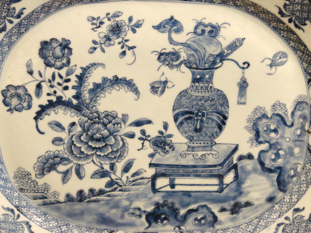 A lovely pair of Chinese export blue and white octagonal platters
decorated with floral motifs around a vase on stand, the borders compatibly decorated.