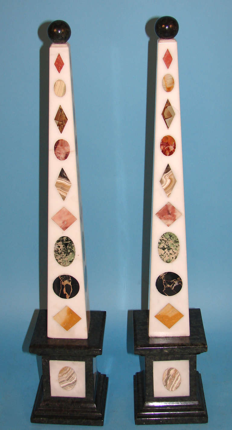 A pair of Italian Neoclassical style specimen marble obelisks, each inlaid column with 10 different examples of marble.