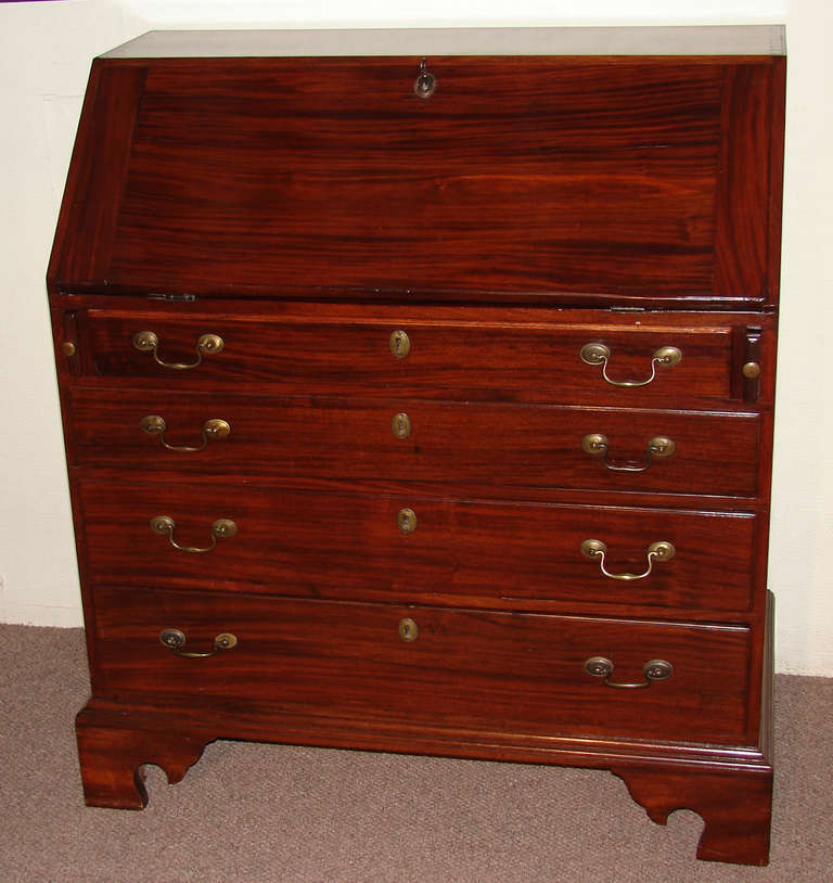 An American Chippendale period mahogany slant front desk, the attractive blocked interior with a shell carved prospect door and 4 shaped drawers all over 4 graduated drawers ending on bracket feet.