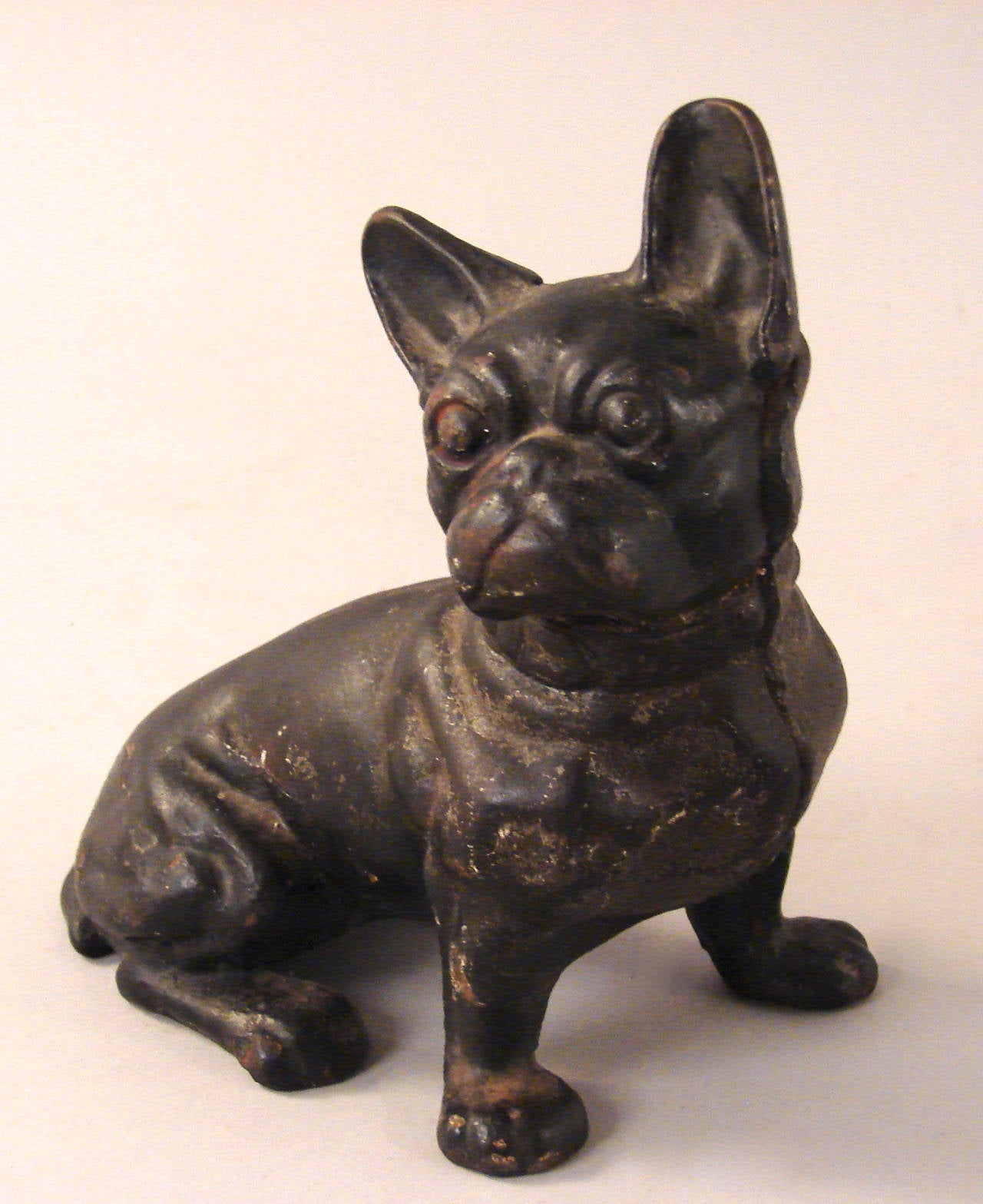 A collection of three Boston Terrier dog cast iron door stops and a cast iron Boston Terrier dog bank together with a French Bulldog cast iron door stop. Great patina and old paint, circa 1900-1925.