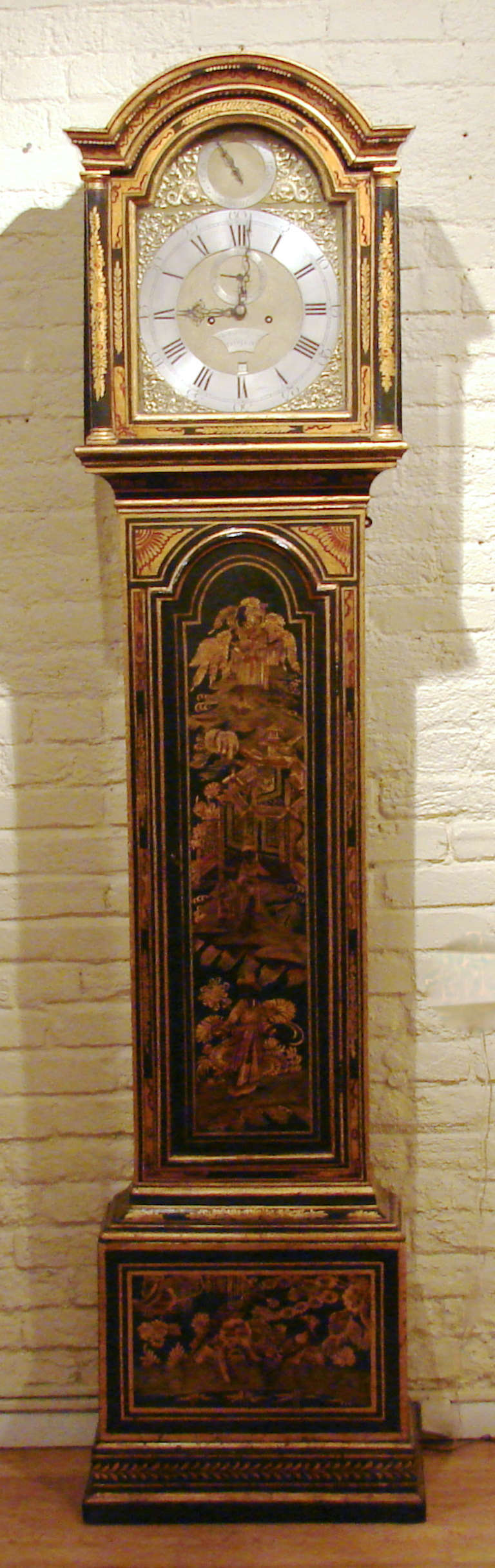 An attractive George III period tall case clock, the 8 day time and strike movement made and signed by James Scholefield, London, circa 1770. The later decorated dark turquoise case depicting Chinese figures in a garden setting with buildings and