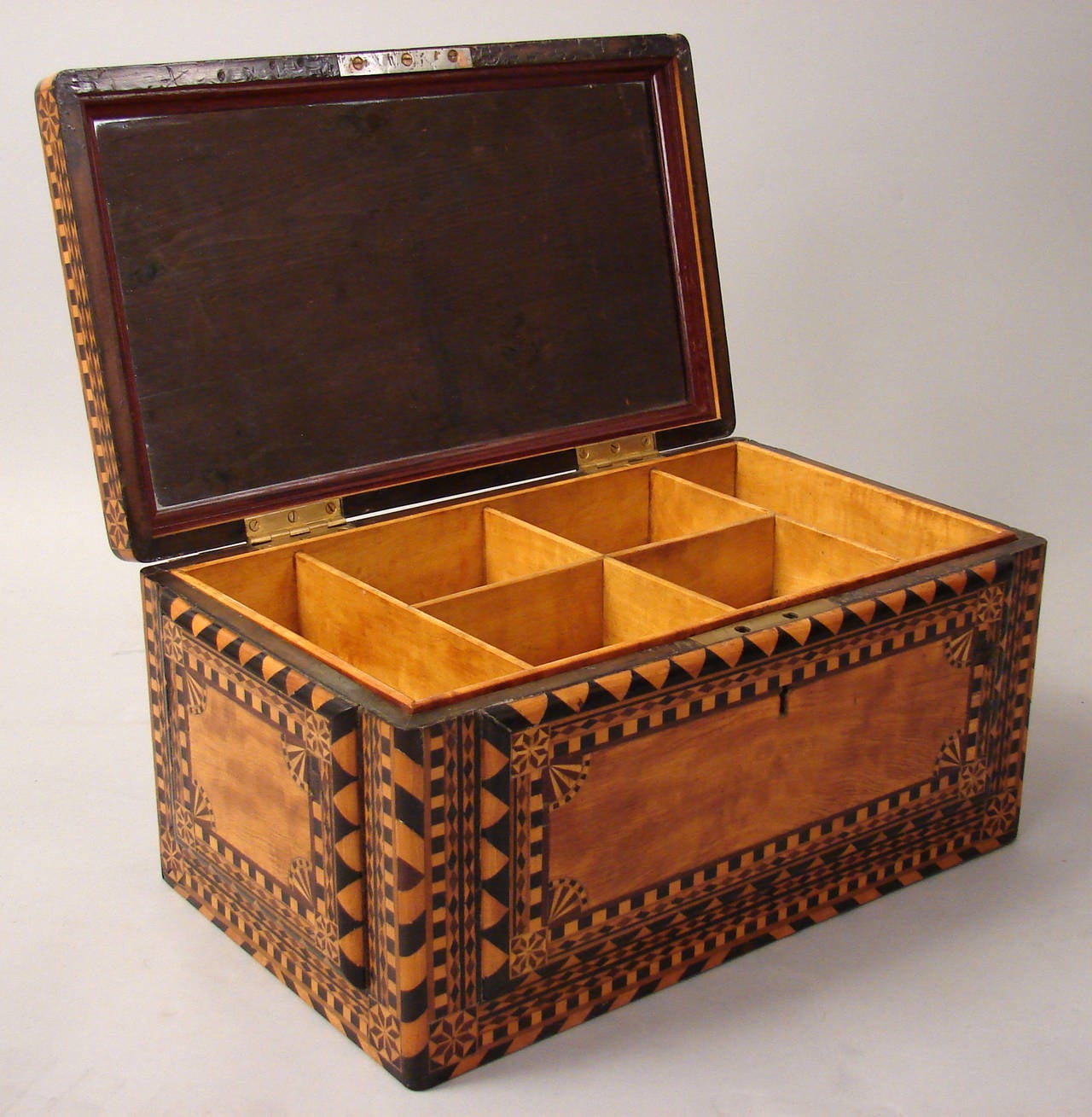 A fine quality Northern European inlaid satinwood jewelry box of impressive scale, the interior with a removable divided tray and a mirror inset in the lid,
the box elaborately inlaid in a geometric patter, circa 1850-1880.