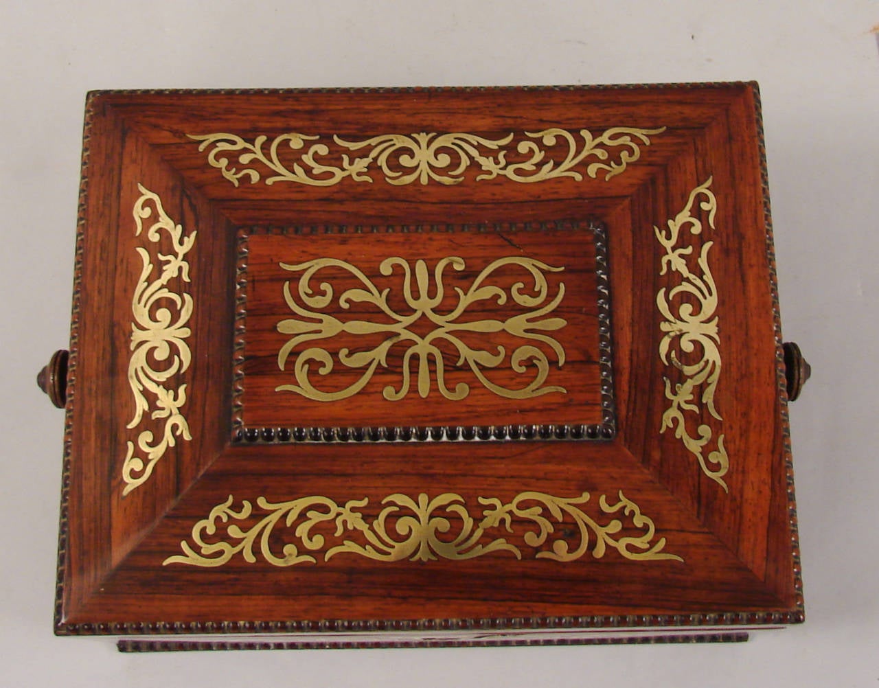 A late Regency period rosewood brass inlaid work box containing a gilt-tooled leather fold out letter file, the interior now lined in blue paper, circa 1835.