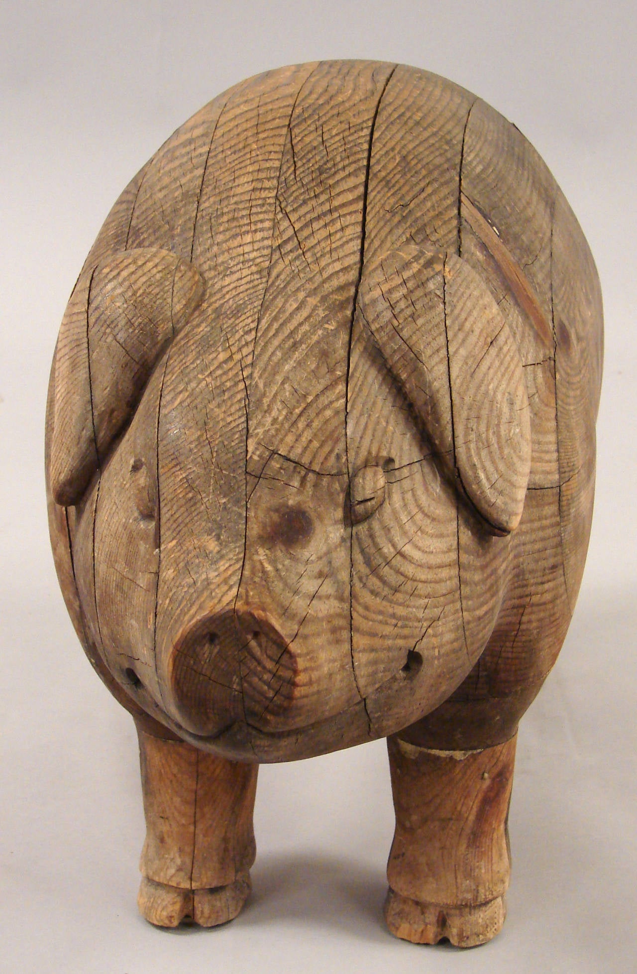 An amusing and substantial laminated oak pig of undetermined origin, circa 1920.
