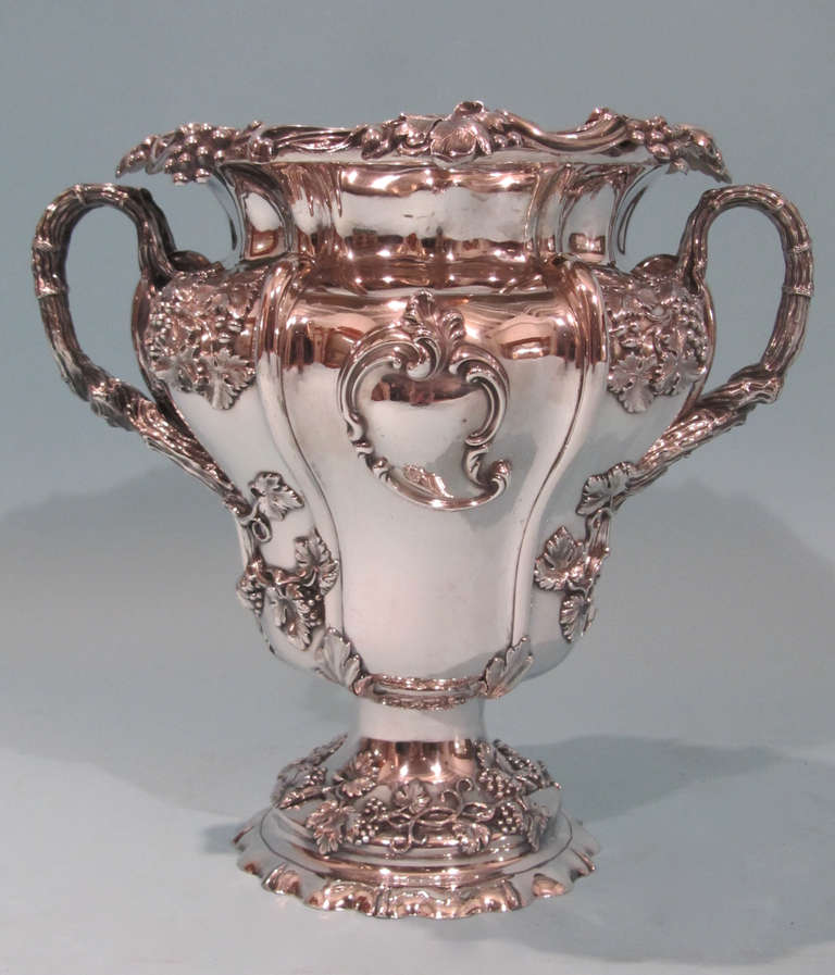 A fine 19th century Victorian silverplate wine cooler by T. & J.Creswick, Sheffield, the melon form body with a downswept grape band collared rim, twin entwining branch form handles cast with sprays of grapes, raised on a pedestal dome foot