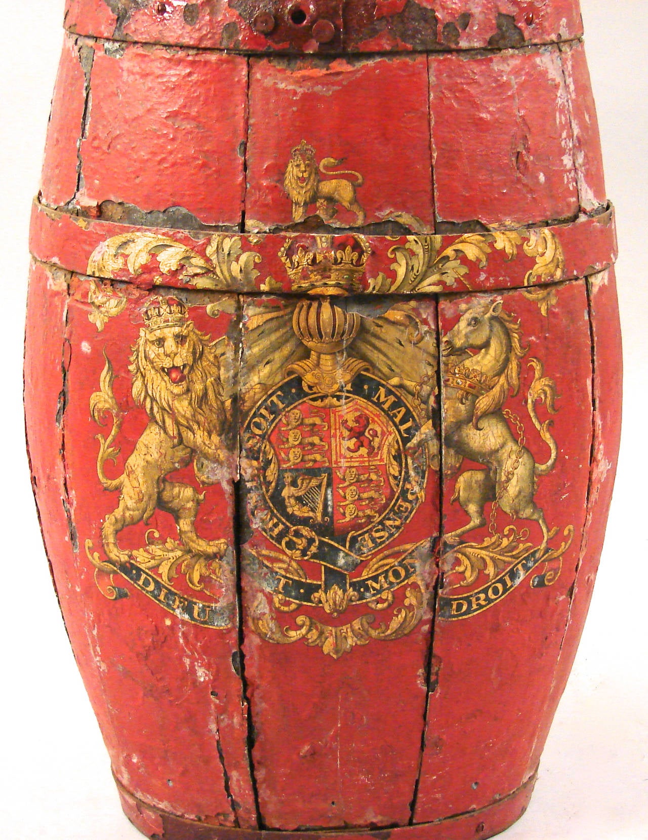 A well-used red painted English barrel with four iron straps decorated with the English coat of arms. Great weathered surface with old paint.