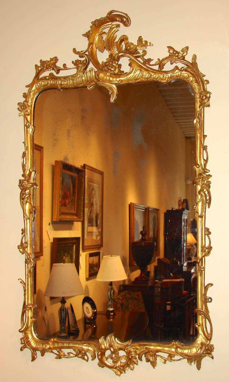 A pretty French Louis XV style Rococo giltwood mirror with overall foliate design, the top with open cresting, retaining its original glass plate.