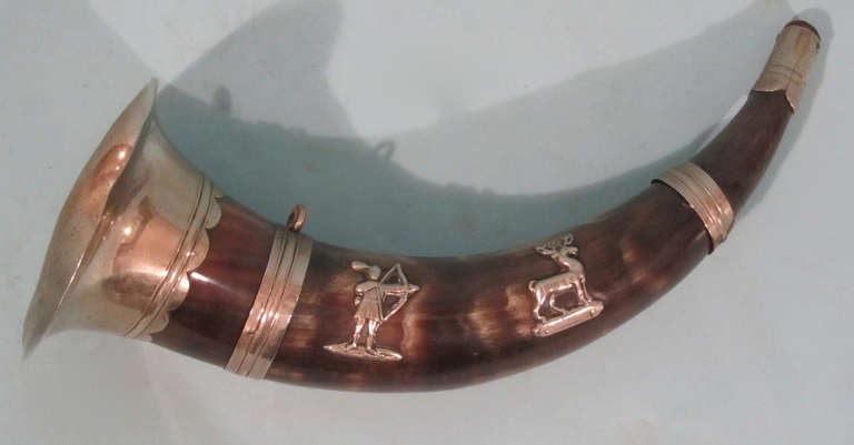 A charming silvered metal mounted hunting horn with applied figures of a  Native American shooting a stag.