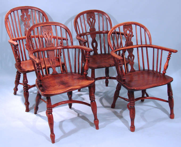 An assembled set of 4 English yew wood and elm lowback Windsor armchairs, 3 with crinoline stretchers one with 