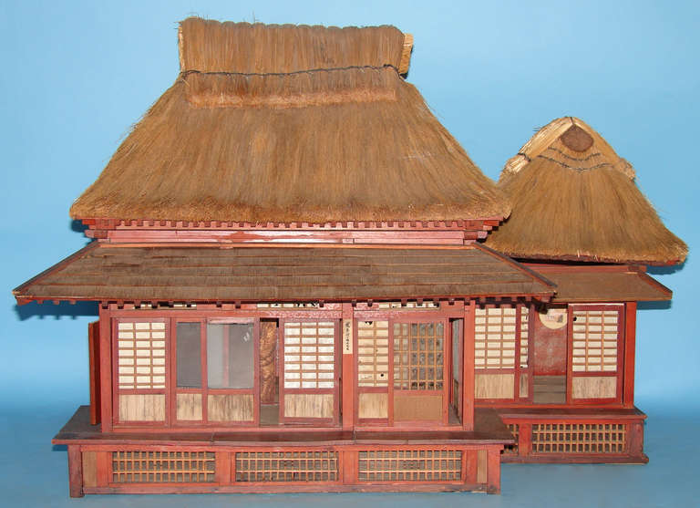 A wonderful Japanese model of a traditional tea house, each room with latticework sliding doors, tatami mats and miniature decorations hanging on the walls, the whole with two removable thatched roofs.
This item is for local delivery only within a