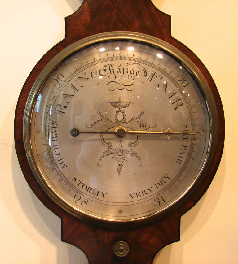A large English mahogany wheel barometer made and signed by B. Bordoli, complete with thermometer, hydrometer mirror and level in addition to a functioning mercury barometer all housed in a mahogany case.