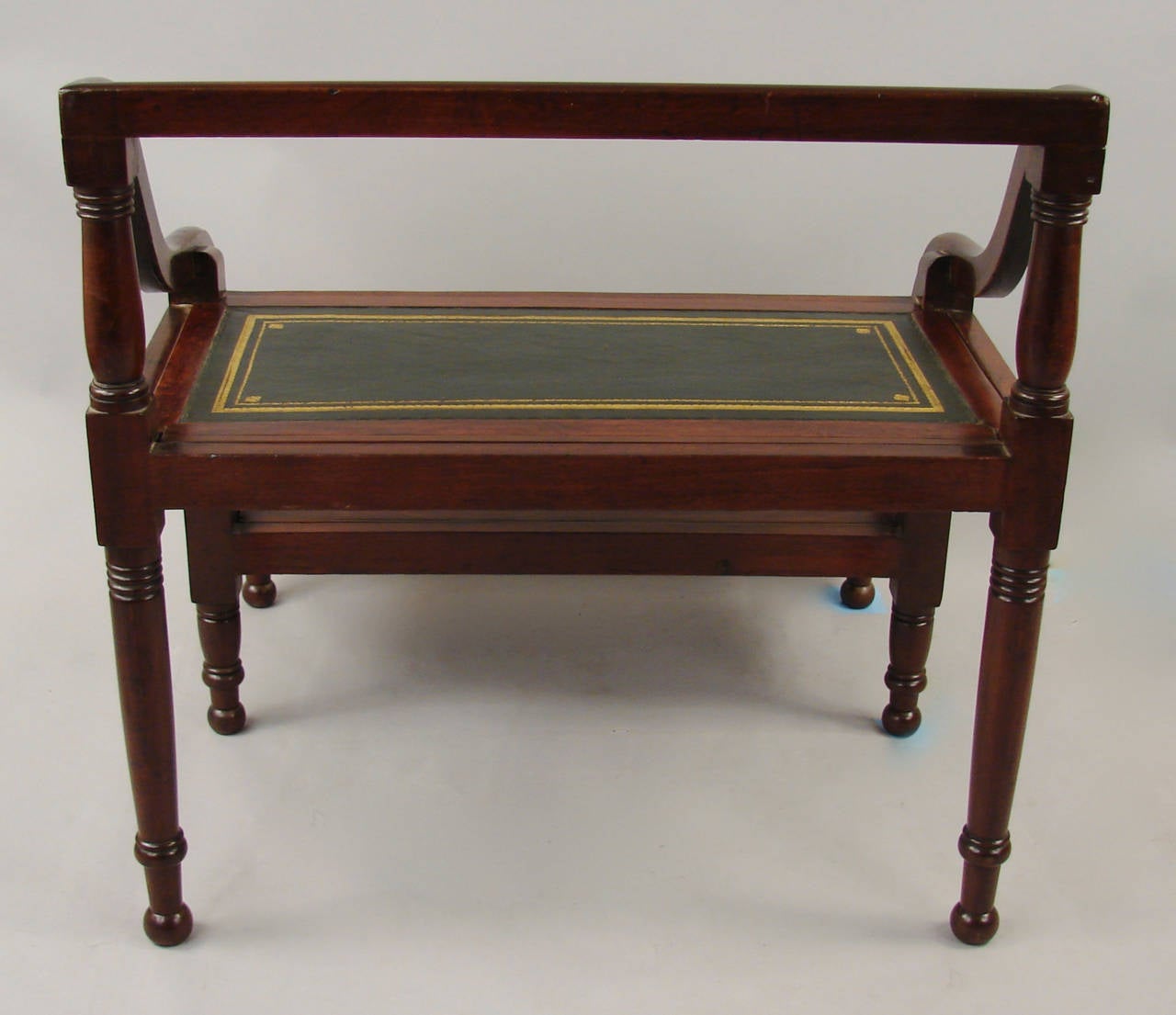 A set of English Regency style mahogany gilt-tooled leather lined library or bed steps with turned legs, circa 1880.