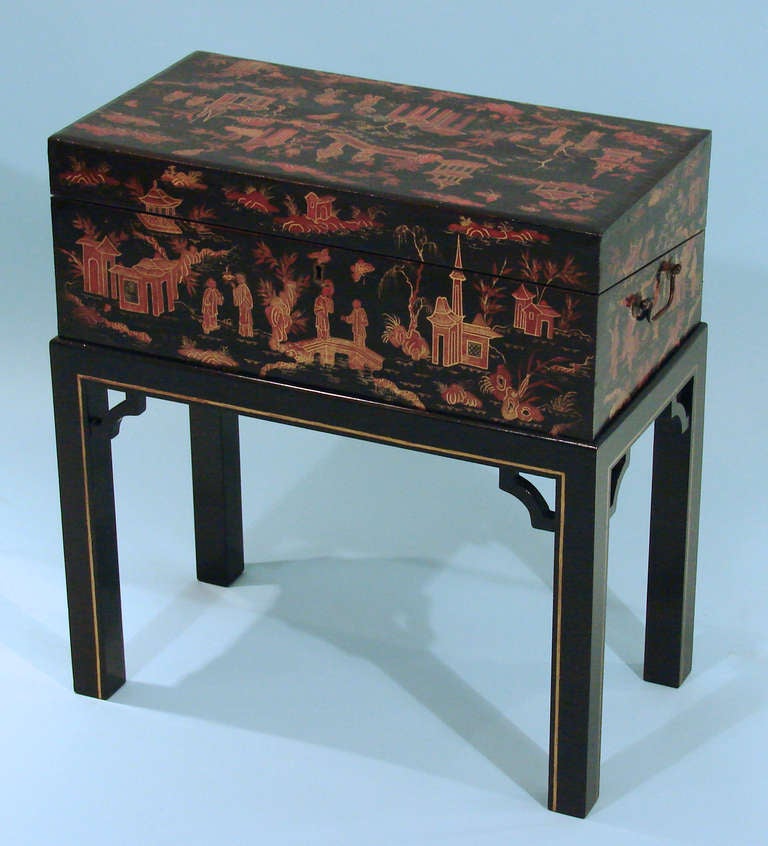 A very pretty Chinese export scarlet lacquer traveling desk circa 1860, decorated overall with figures and structures in an elaborate landscape setting, the interior with compartments for letters and a later velvet covered writing surface, with a