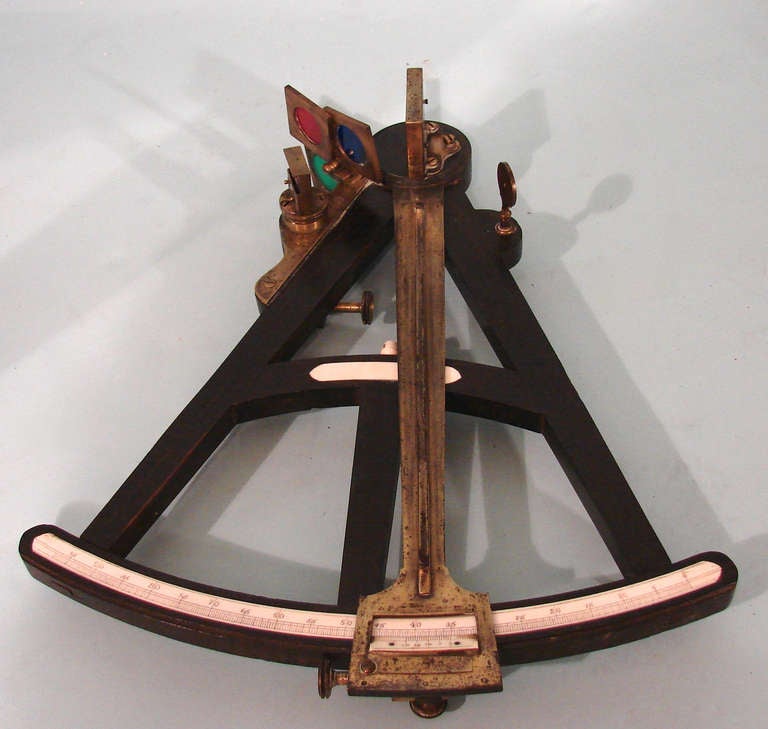 An English ebony and brass octant with an ivory register circa 1800. Unsigned.