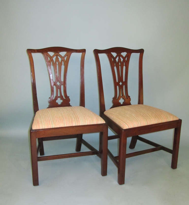A pair of English Chippendale period mahogany side chairs with straight legs and drop in seats, circa 1770.