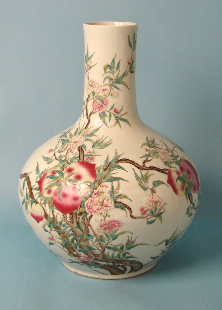 An impressive Chinese bottleneck vase of large scale decorated in the famille rose palette with peaches and vines bearing a Chien Lung mark. Circa 1880-1900. Repaired.