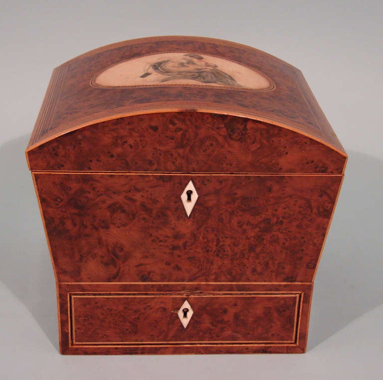 An English Regency burr yew wood lady's sewing box, the domed lid with a vignette of a woman in long robes seated in a neoclassical chair, inlaid with satinwood stringing, circa 1810. Provenance: Malcolm Franklin Antiques, Chicago.