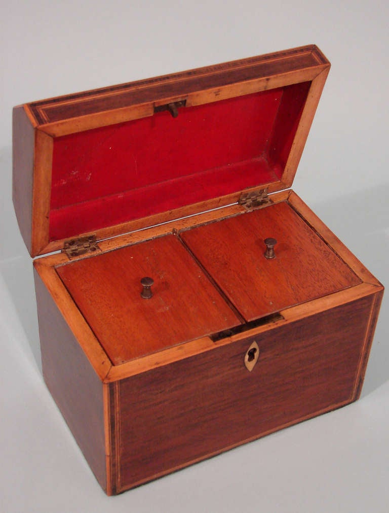 An English George III partridge wood tea caddy with chamfered rectangular and banded borders opening to a case fitted with two compartments. Provenance: Dillingham and Co. Circa 1790.
