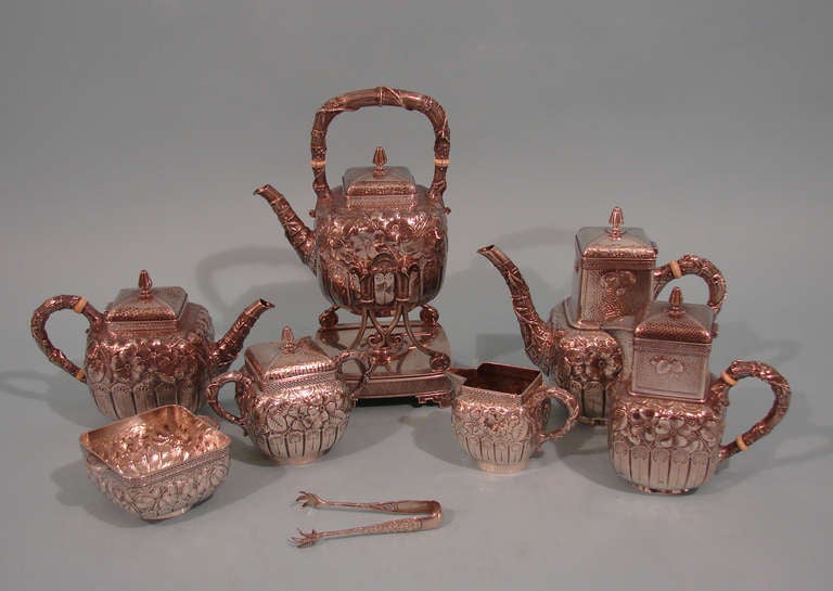 A rare and spectacular aesthetic movement 8 piece sterling silver tea and coffee service in the Eglantine pattern made and signed by Gorham, consisting of a hot water kettle with stand, coffee pot, teapot, milk pitcher, cream pitcher, sugar bowl