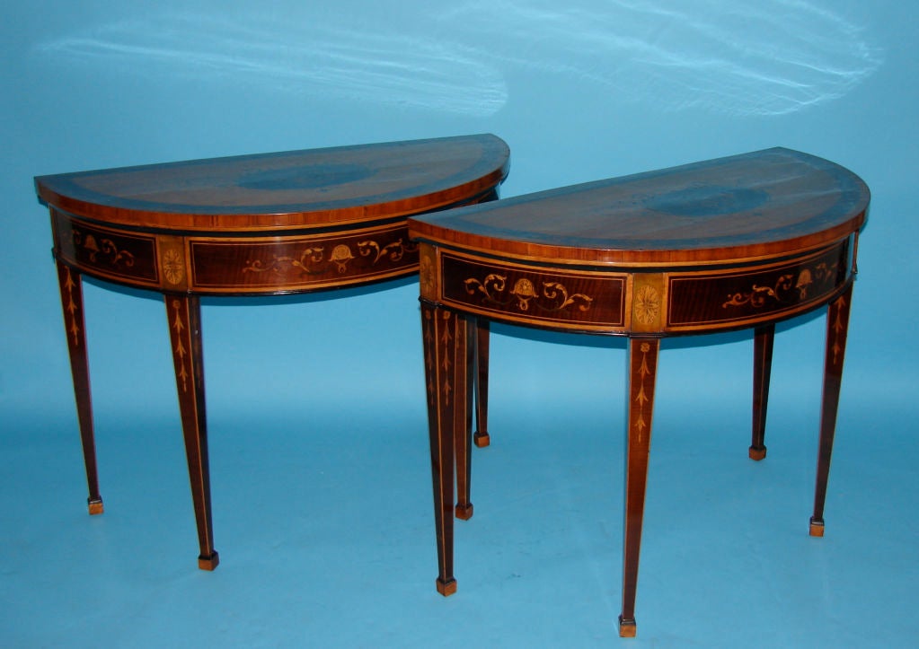 A pair of beautifully inlaid Hepplewhite demi-lune tables