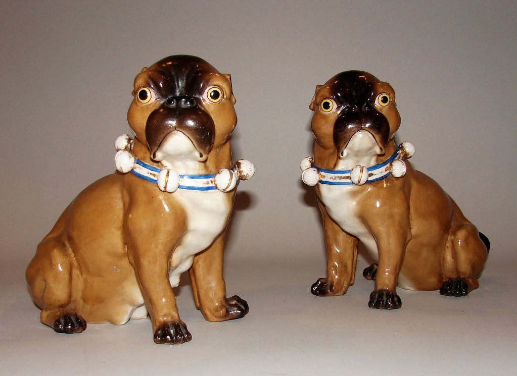 A pair of Meissen style pug dogs  after a model by JJ Kandler each bearing a blue 