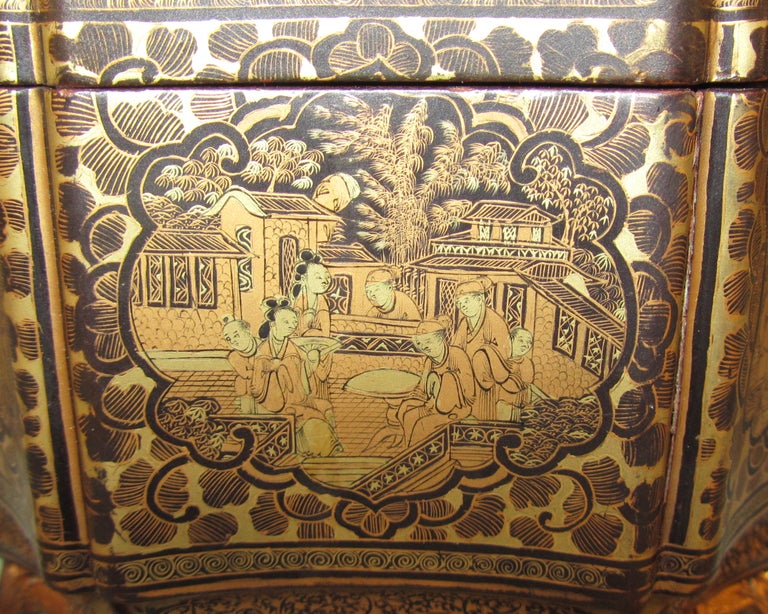 A fine Chinese export tea caddy, the gilt decorated lacquered case in excellent condition opening to reveal 2 original pewter tea canisters with lids,  all resting on carved stylized animal paw feet.