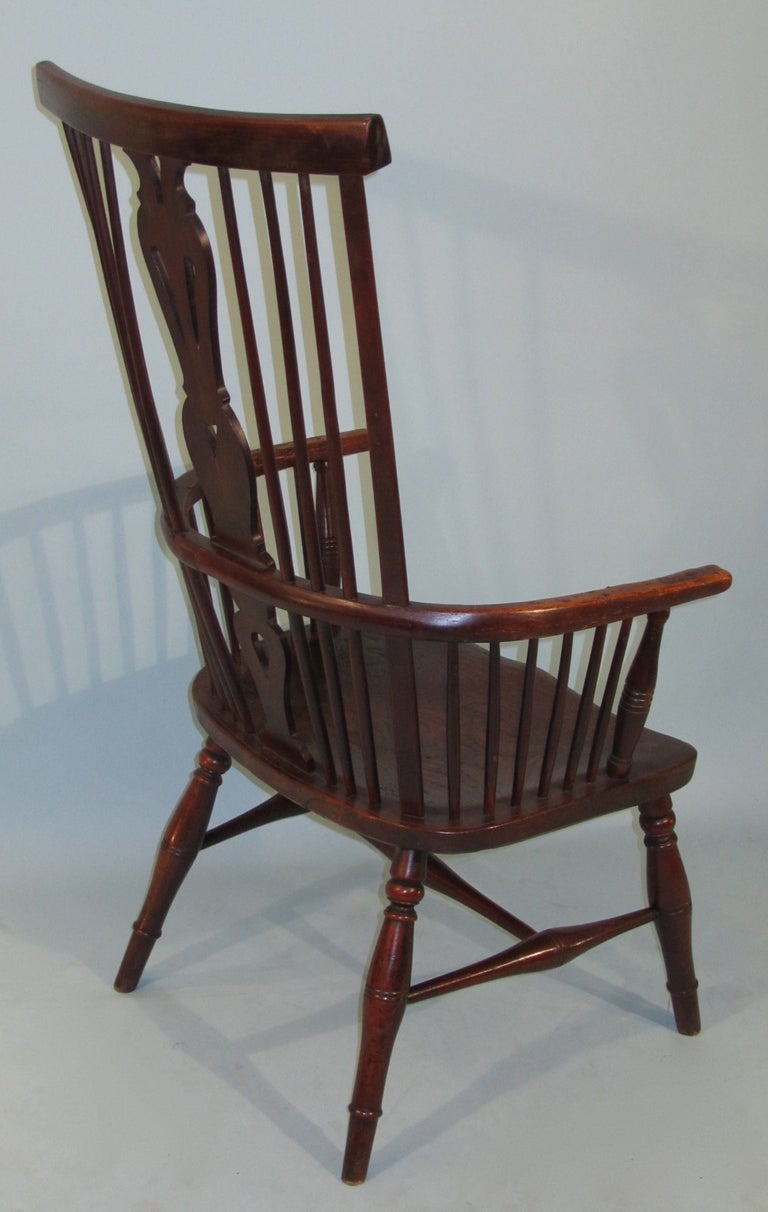 A large scale elm Thames Valley windsor chair, the spindle back centered by a pierced splat the saddle seat above turned legs joined by an 