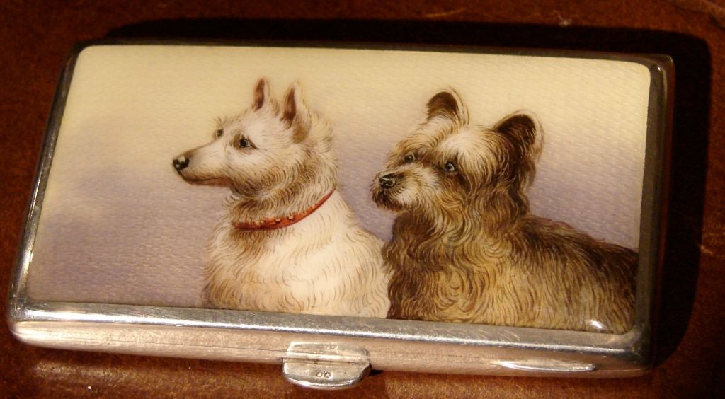 A charming English silver and enamel cigarette case, the lid depicting two terriers. Circa 1900.