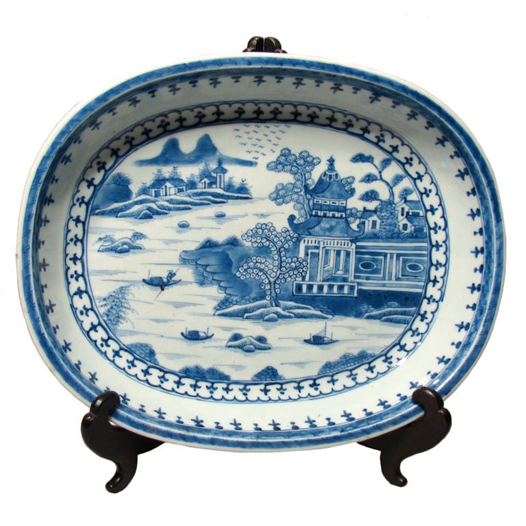 An attractive Chinese blue Canton deep platter typically decorated with houses boats and trees, circa 1860.
