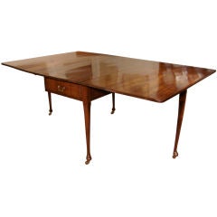 Large George II figured mahogany drop leaf dining table