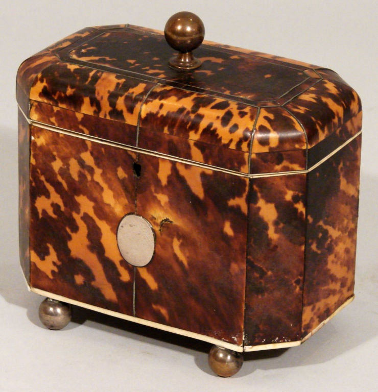 An English tortoiseshell, ivory banded and metal strung tea caddy.