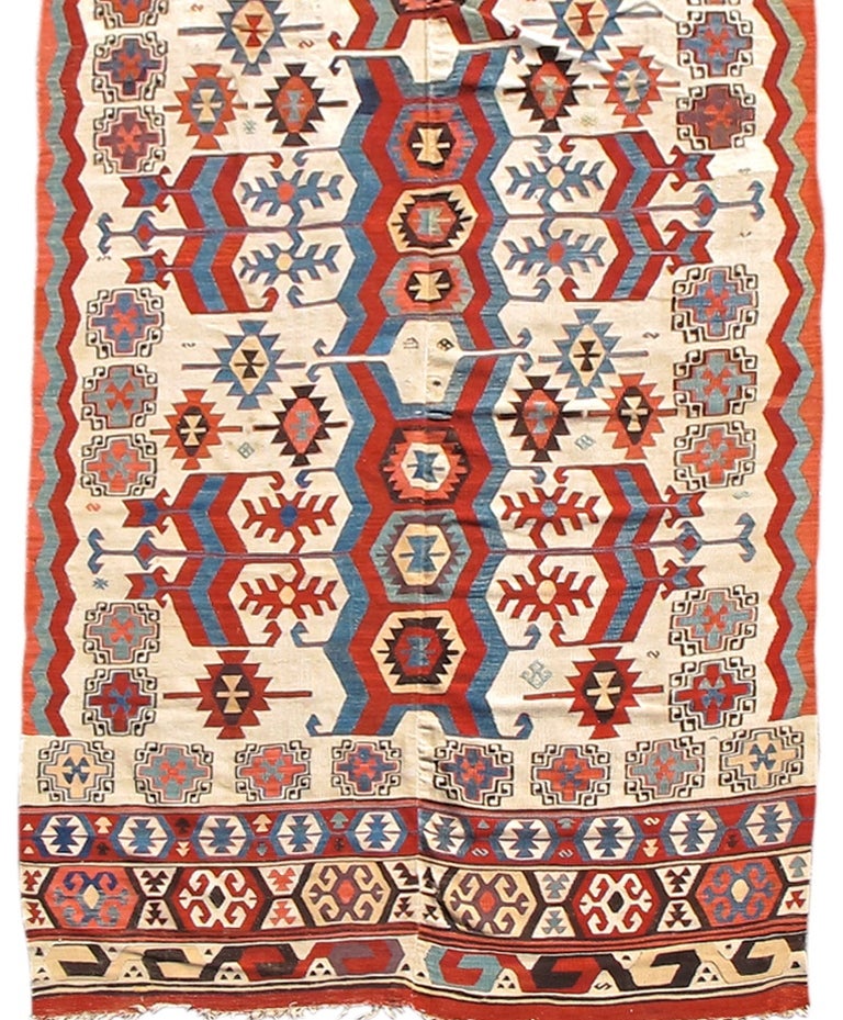 Bold dynamic colorful abstract drawing leaps forth from the ivory ground of this impressive Turkish Kilim from the region around Konya in central Anatolia. This piece reads well visually both vertically as well as horizontally. Displayed vertically,