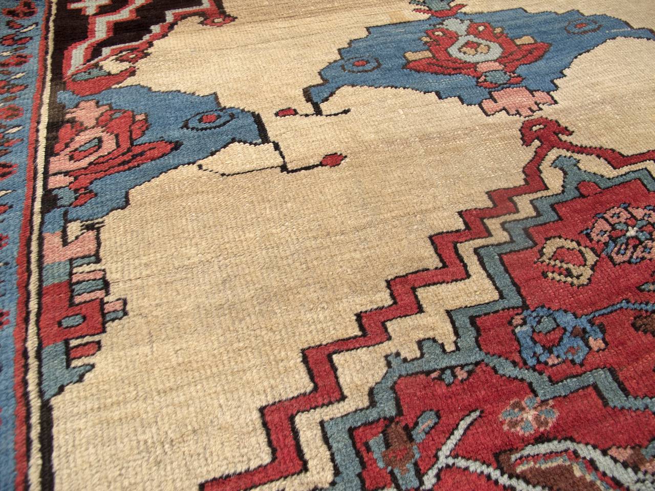 Bakhshaish carpets are arguably the most playful group of the more formal Northwest Persian varieties. This, however, does not preclude a proclivity for elegance. A Classic Persian medallion floats against a light modulated camel ground. Shades of
